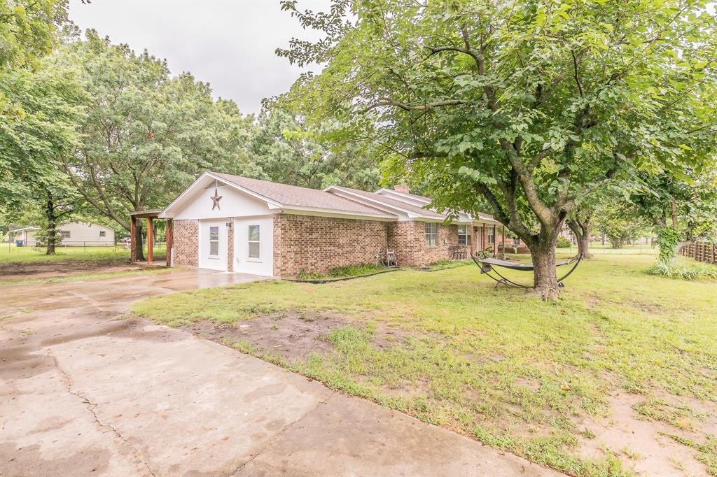904 Sherman Street Tioga, TX 76271 - Photo 4 of 40 a front view of a house with yard and tree