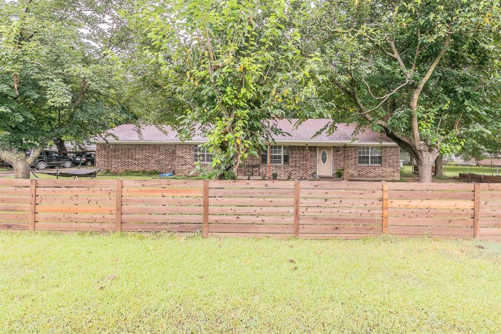 904 Sherman Street Tioga, TX 76271 - Photo 5 of 40 a front view of a house with a yard
