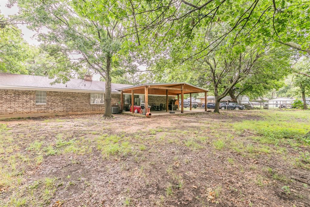 904 Sherman Street Tioga, TX 76271 - Photo 8 of 40 a view of house with yard and outdoor seating
