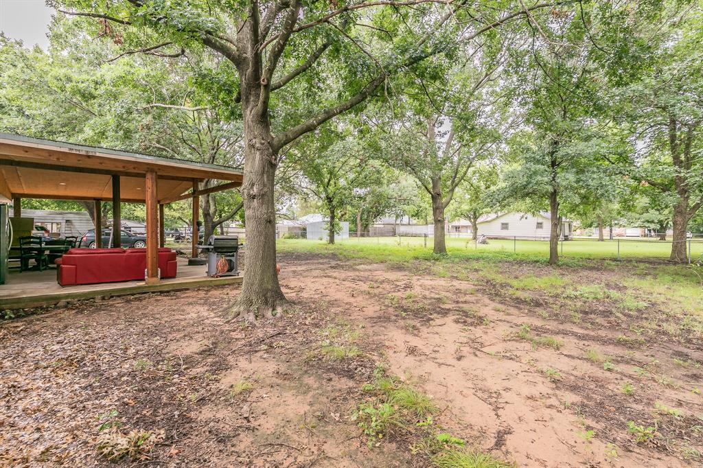 904 Sherman Street Tioga, TX 76271 - Photo 10 of 40 a view of a house with backyard and trees