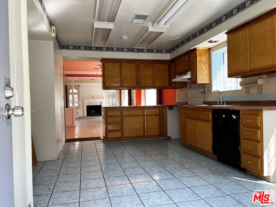 1151 Forest Avenue Pasadena, CA 91103 - Photo 8 of 15 a kitchen with stainless steel appliances granite countertop a sink cabinets and window