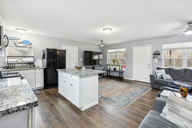 a living room with furniture and a dining table