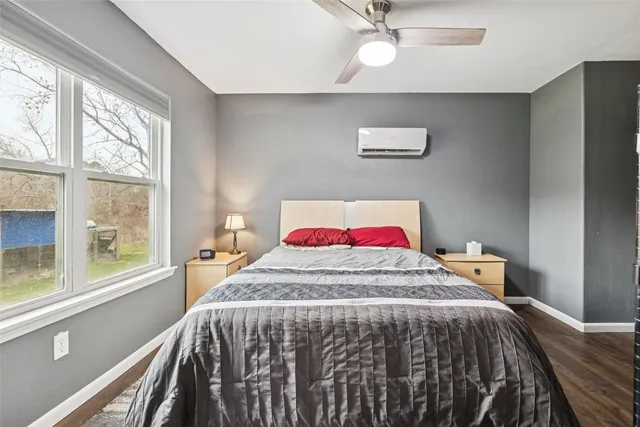 a bedroom with a bed and a large mirror