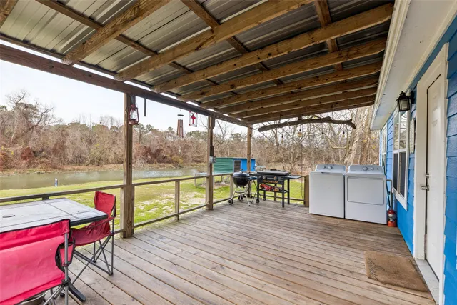 a living room with a couch and a view of kitchen appliances