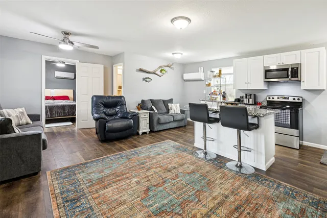 a large kitchen with cabinets wooden floor counter space and stainless steel appliances