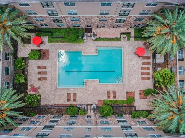 a front view of a multi story building with yard