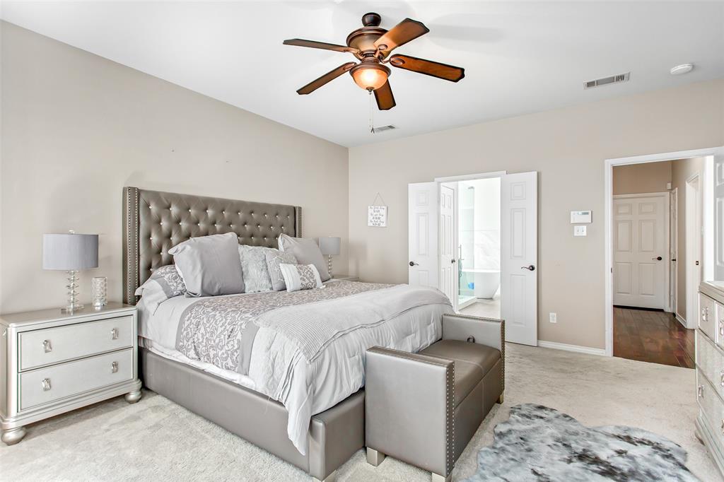 5916 Mossbrook Trail Dallas, TX 75252 - Photo 13 of 40 a bedroom with a bed and a chandelier