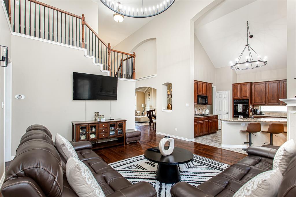 5916 Mossbrook Trail Dallas, TX 75252 - Photo 15 of 40 a living room with furniture fireplace and a flat screen tv