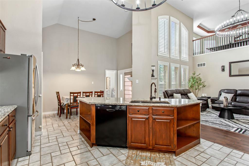 5916 Mossbrook Trail Dallas, TX 75252 - Photo 17 of 40 a open kitchen with stainless steel appliances granite countertop a stove refrigerator and cabinets