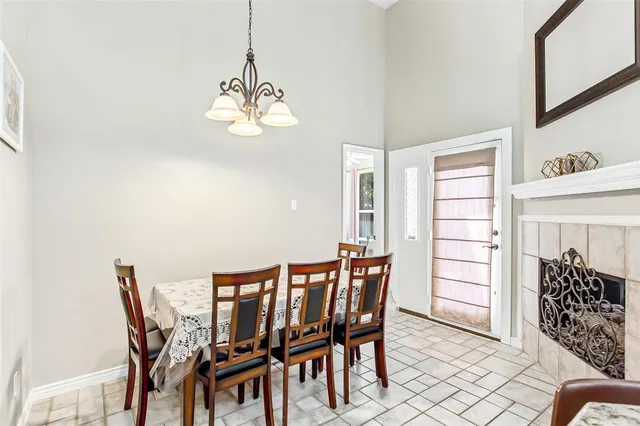 a view of a dining room with furniture and chandelier