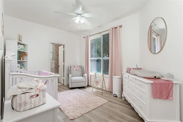 a spacious bedroom with a bed a couch and dresser