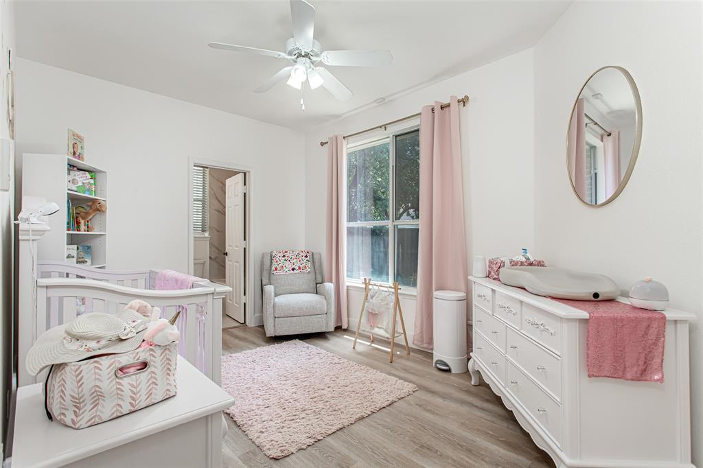 5916 Mossbrook Trail Dallas, TX 75252 - Photo 19 of 40 a spacious bedroom with a bed a couch and dresser