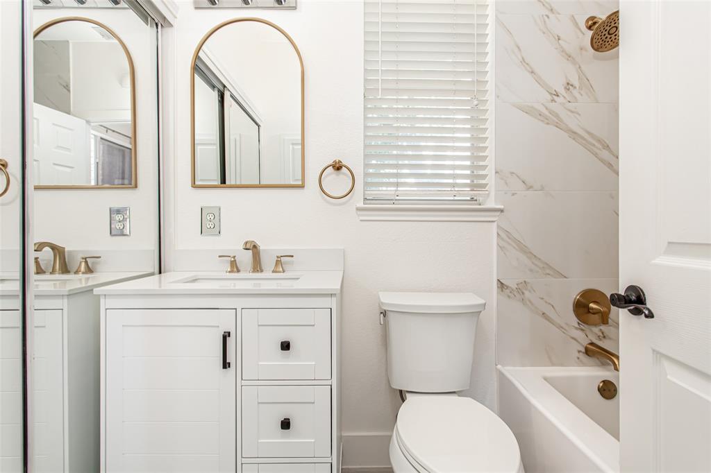 5916 Mossbrook Trail Dallas, TX 75252 - Photo 20 of 40 a bathroom with a granite countertop toilet sink and mirror