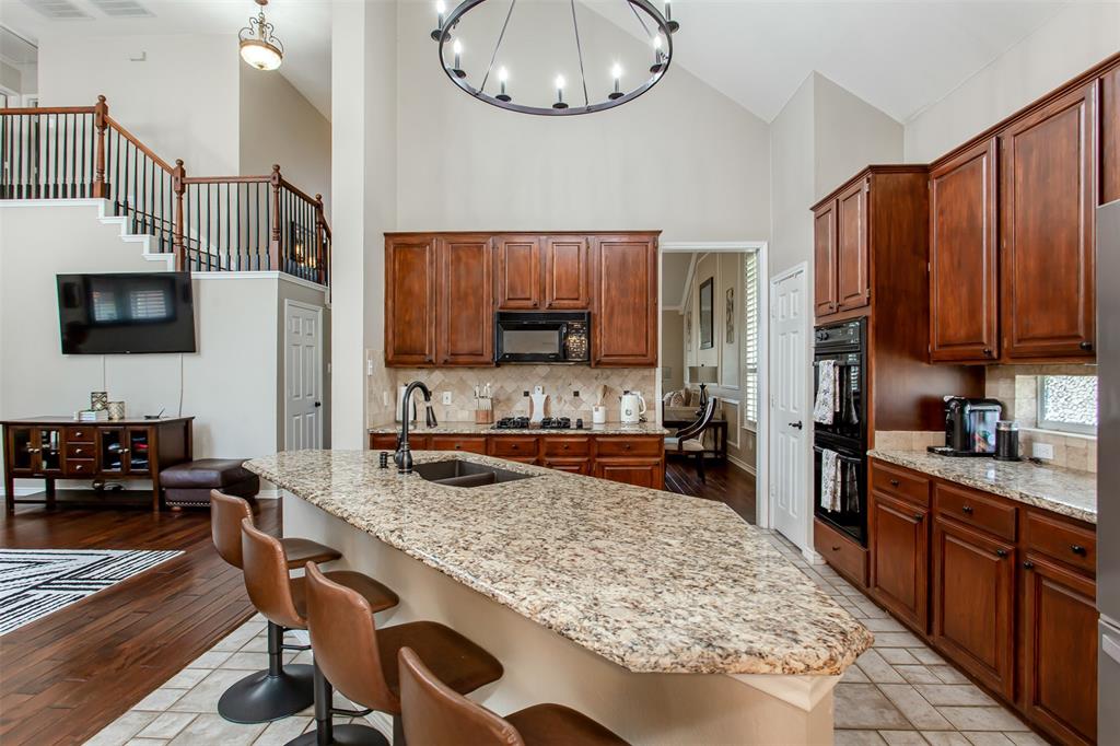 5916 Mossbrook Trail Dallas, TX 75252 - Photo 24 of 40 a kitchen with stainless steel appliances granite countertop a stove refrigerator and a sink