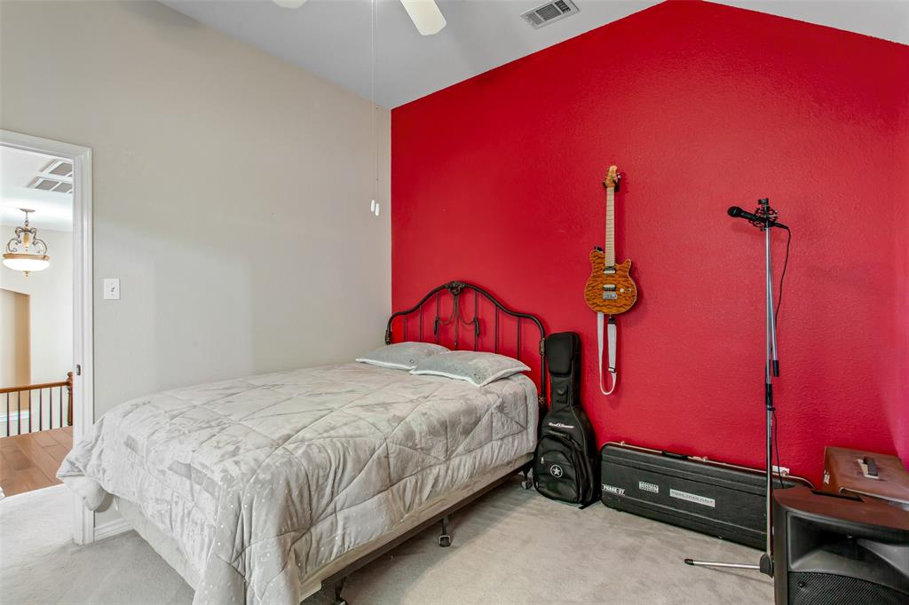 5916 Mossbrook Trail Dallas, TX 75252 - Photo 27 of 40 a bedroom with a bed and a table