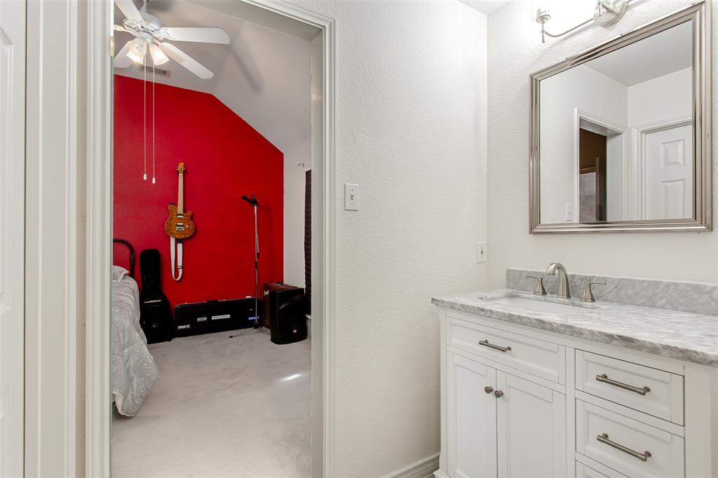 5916 Mossbrook Trail Dallas, TX 75252 - Photo 28 of 40 a bathroom with a sink and a mirror