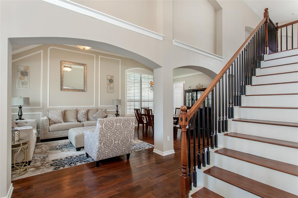 5916 Mossbrook Trail Dallas, TX 75252 - Photo 3 of 40 a living room with furniture and a wooden floor