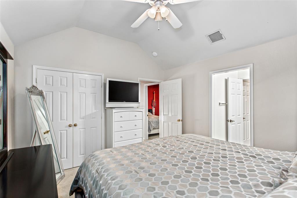 5916 Mossbrook Trail Dallas, TX 75252 - Photo 31 of 40 a bedroom with a bed and a flat screen tv