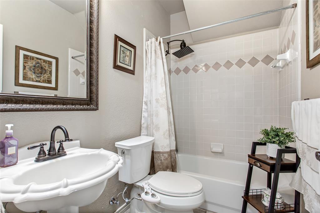 5916 Mossbrook Trail Dallas, TX 75252 - Photo 36 of 40 a bathroom with a sink toilet and shower