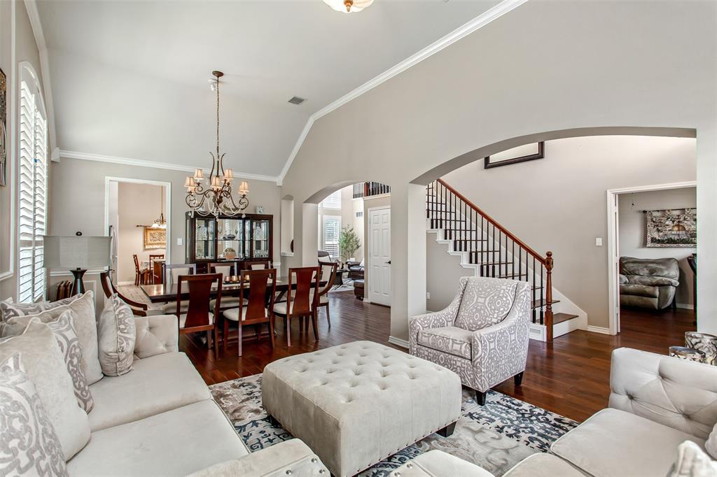 5916 Mossbrook Trail Dallas, TX 75252 - Photo 5 of 40 a living room with furniture dining table a rug and a chandelier
