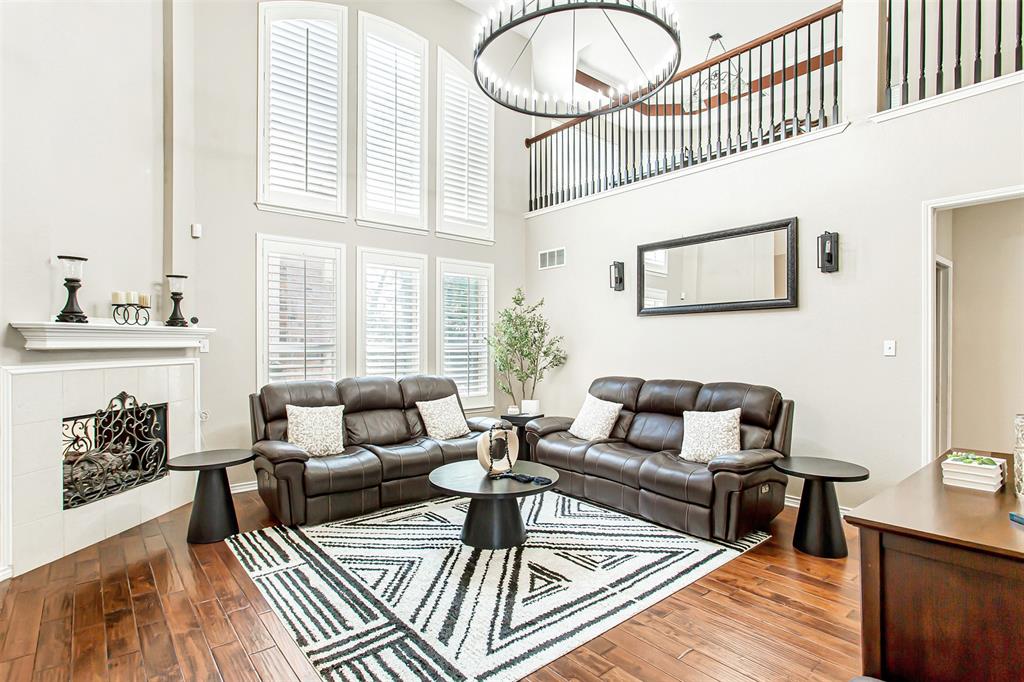 5916 Mossbrook Trail Dallas, TX 75252 - Photo 9 of 40 a living room with furniture a fireplace and wooden floor