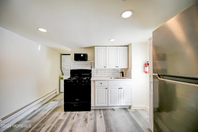 a kitchen with a refrigerator and a stove top oven