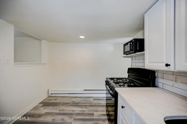 a kitchen with a stove and a refrigerator
