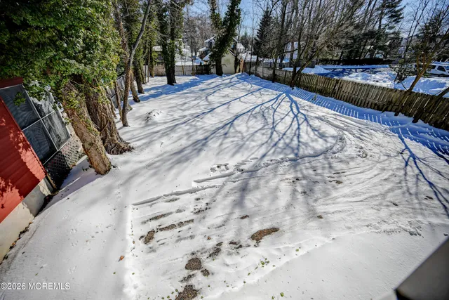 a view of backyard with large trees