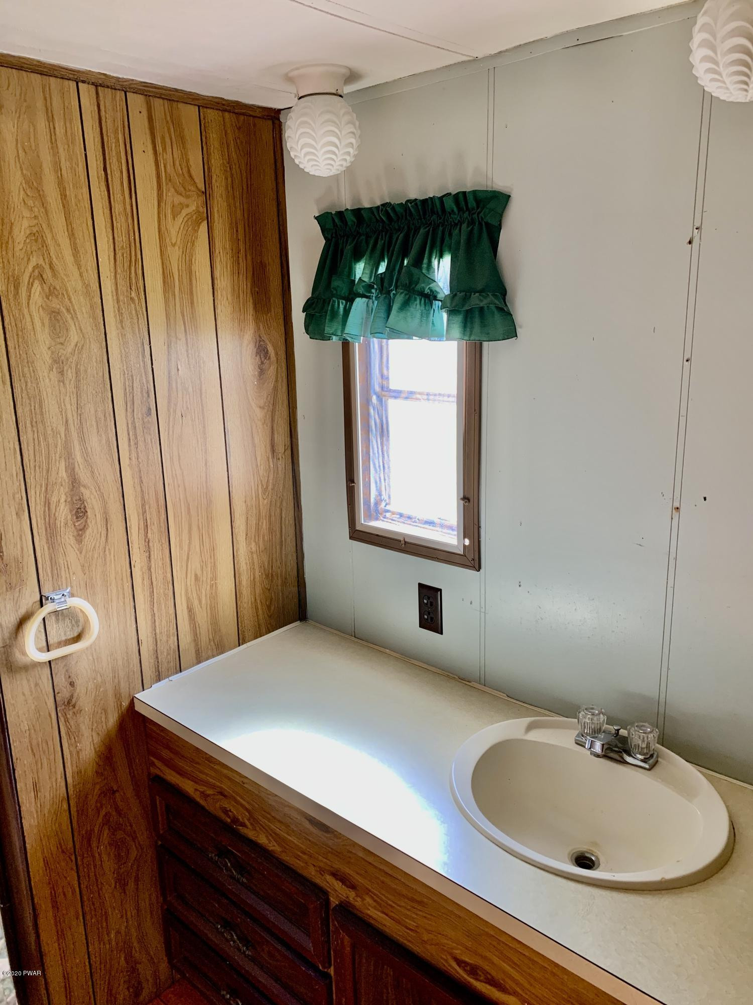 99 Slater Road Beach Lake, PA 18405 - Photo 25 of 35 a bathroom with a sink and a mirror