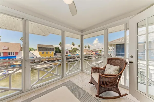 a dining room with furniture and a floor to ceiling window