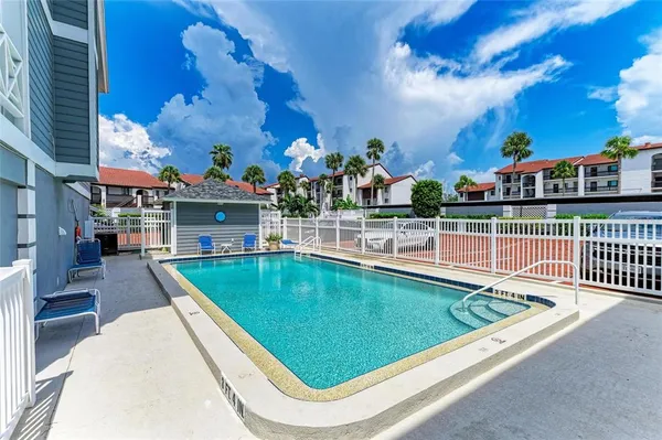a view of a swimming pool with a deck and a fireplace