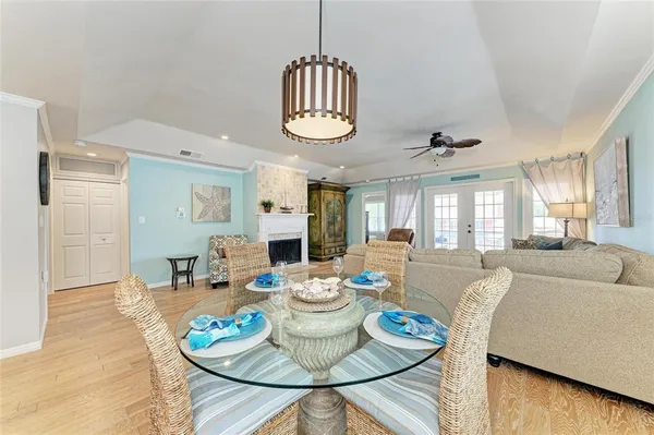 a dining room with furniture a rug and wooden floor