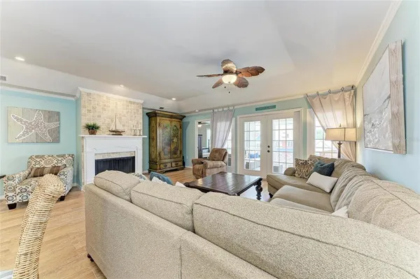 a living room with fireplace furniture and a large window