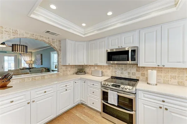 a kitchen with a sink stove and microwave