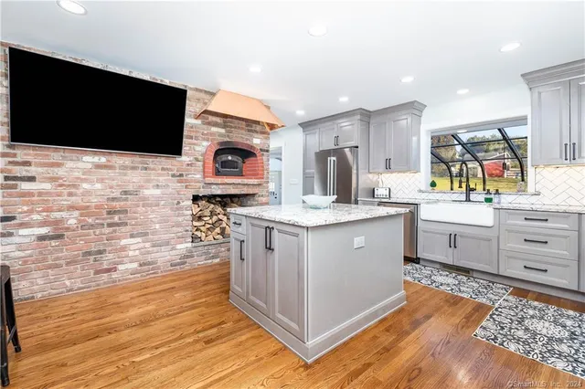 a open kitchen with stainless steel appliances kitchen island granite countertop a sink and cabinets