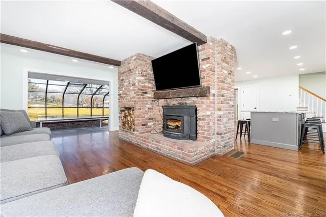 a living room with fireplace furniture and a flat screen tv
