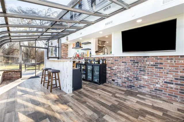 a view of a room with wooden floor and flat screen tv
