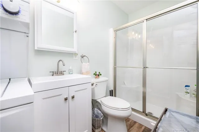 a bathroom with a sink mirror vanity and toilet