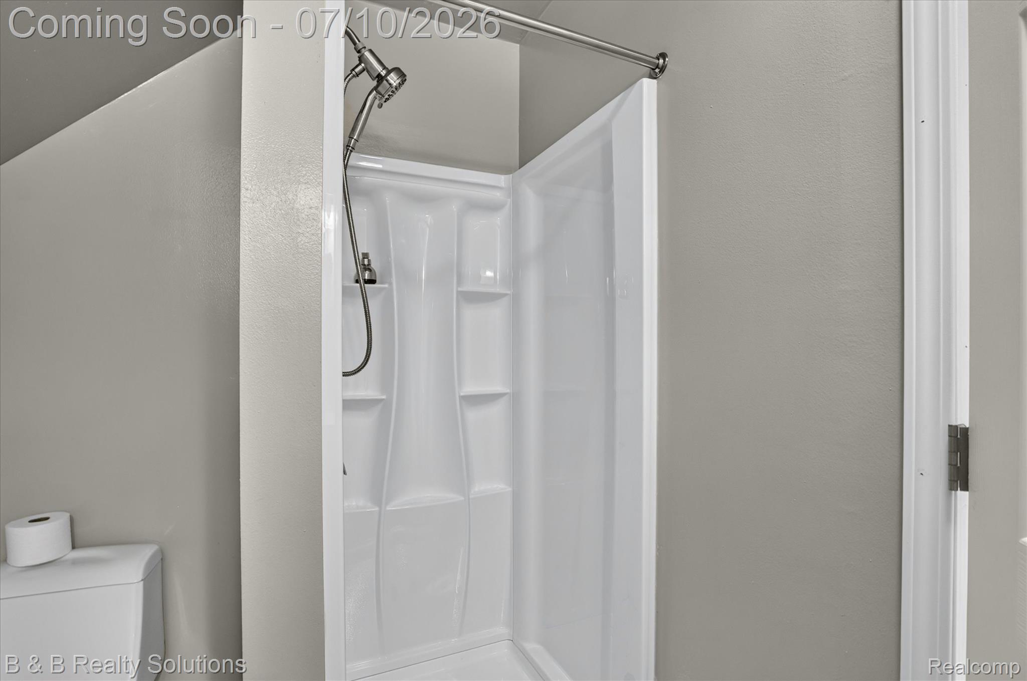 1564 East Burnside Road North Branch, MI 48461 - Photo 18 of 25 Enclosed shower stall with integrated shelving and a brushed nickel shower head