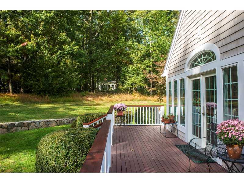 540 Cheese Spring Road New Canaan, CT 06840 - Photo 19 of 25 a view of a wooden deck and a garden