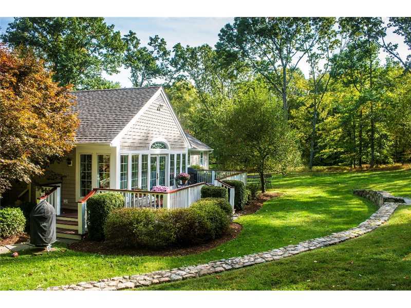 540 Cheese Spring Road New Canaan, CT 06840 - Photo 21 of 25 a view of a house with a big yard and potted plants and large trees
