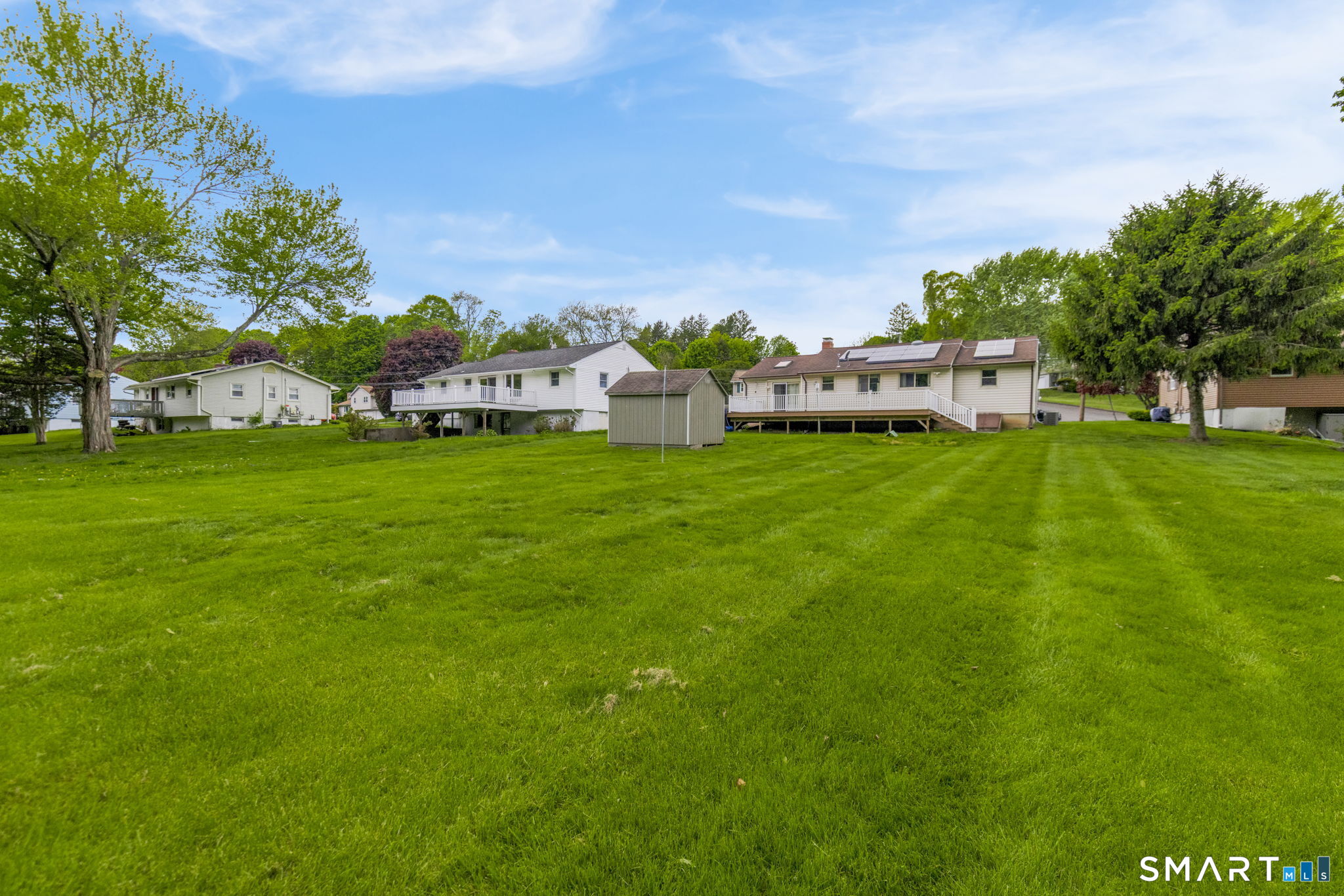 102 Wayne Lane Meriden, CT 06450 - Photo 36 of 36 a backyard of a house with lots of green space and garden view