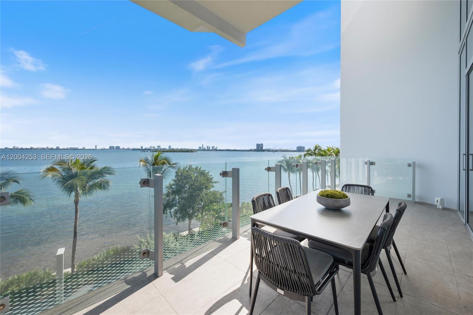 700 Northeast 26th Terrace, Unit TH403 Miami, FL 33137 - Photo 14 of 85 a view of a balcony with table and chairs