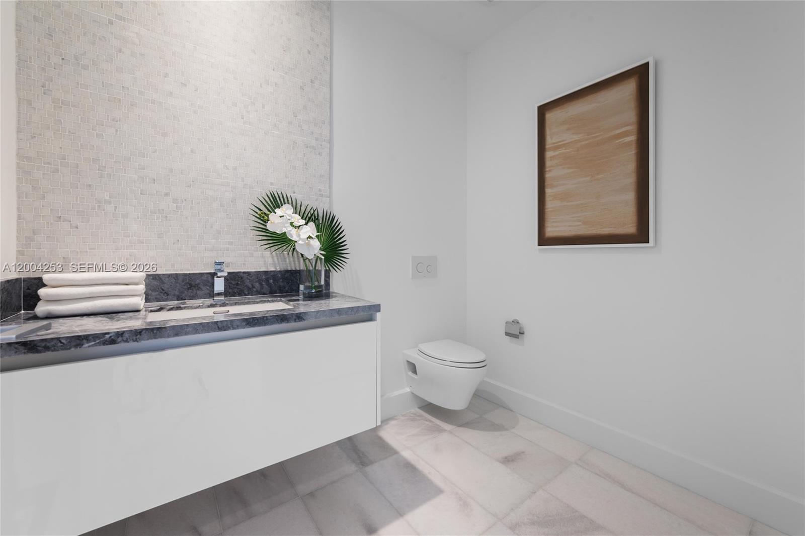 700 Northeast 26th Terrace, Unit TH403 Miami, FL 33137 - Photo 17 of 85 a bathroom with a granite countertop sink and a toilet