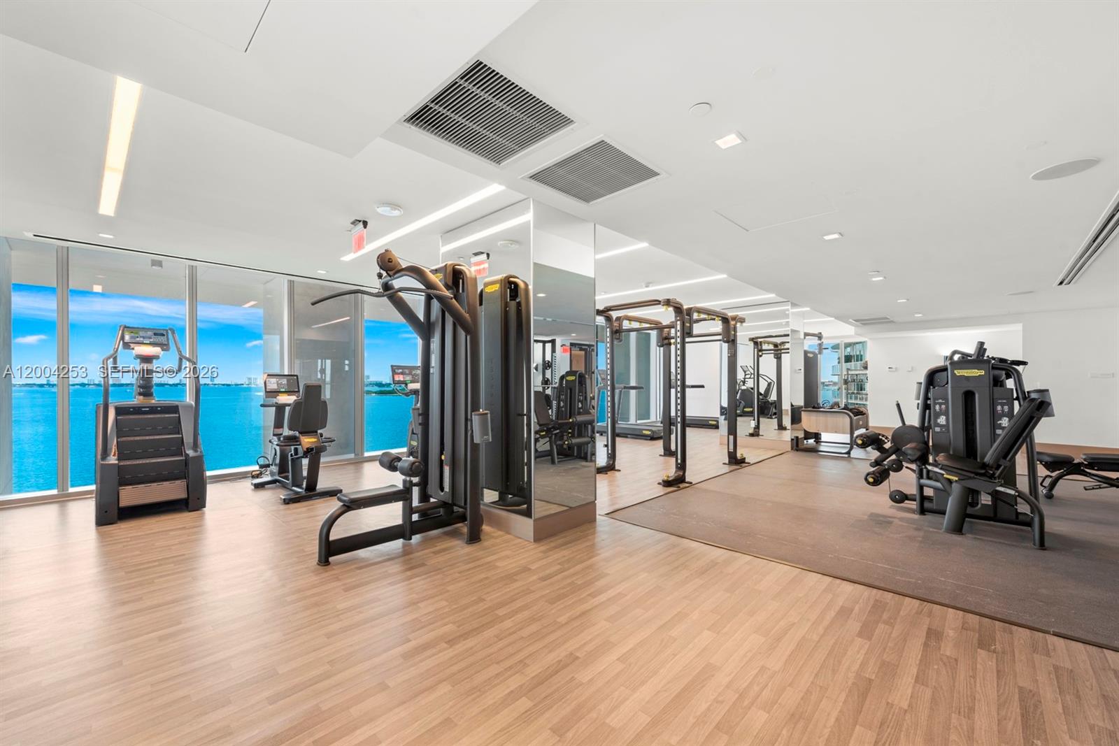 700 Northeast 26th Terrace, Unit TH403 Miami, FL 33137 - Photo 57 of 85 a view of a room with gym equipment and wooden floor