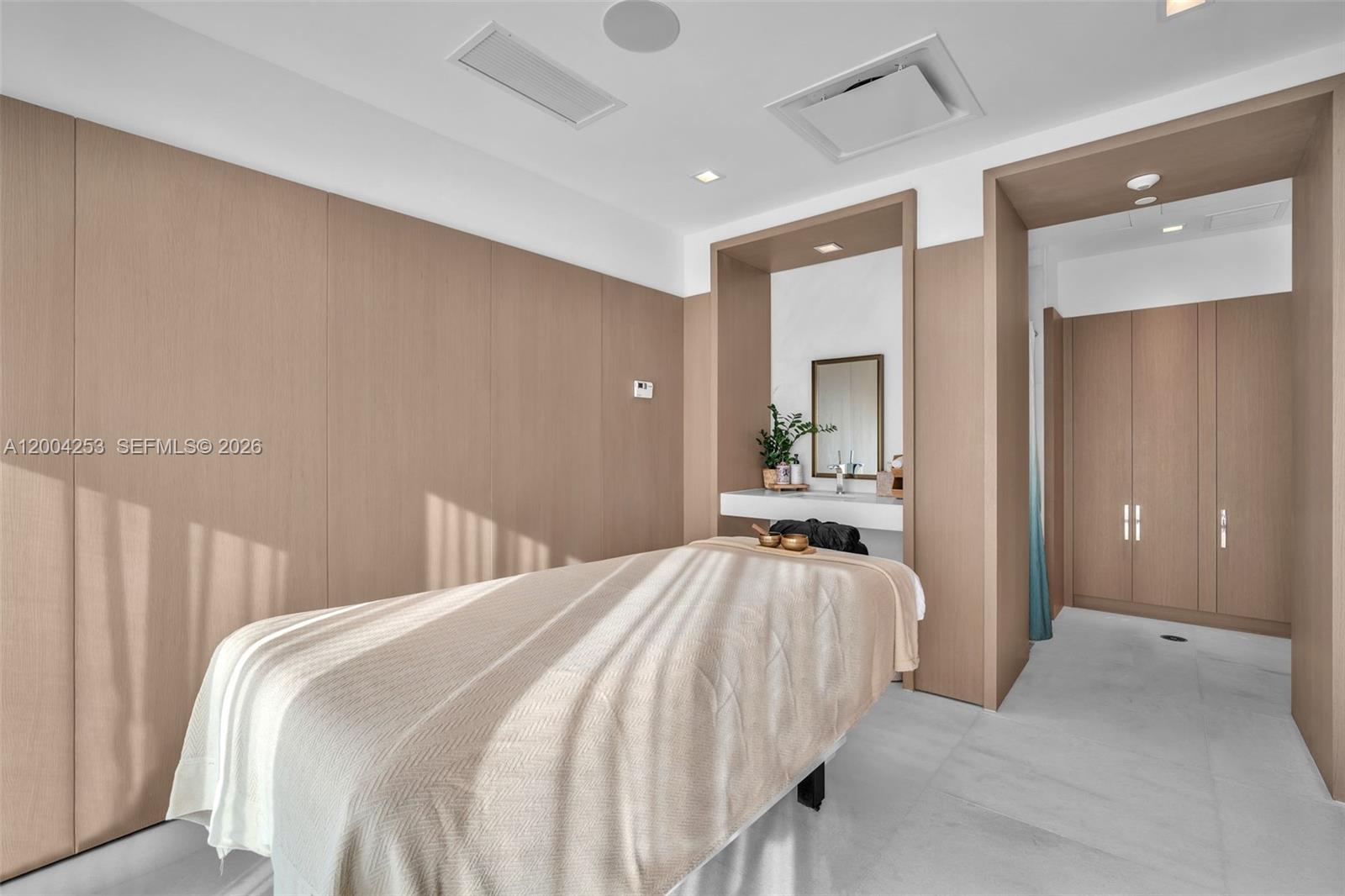 700 Northeast 26th Terrace, Unit TH403 Miami, FL 33137 - Photo 65 of 85 a bedroom with a bed and a large mirror