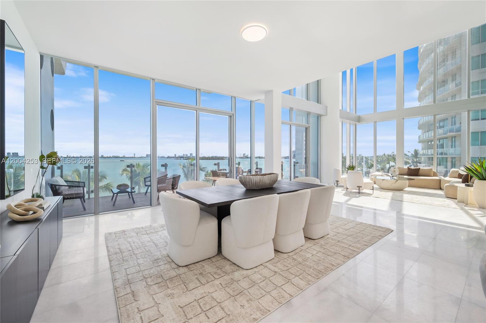 700 Northeast 26th Terrace, Unit TH403 Miami, FL 33137 - Photo 10 of 85 a living room with couches a coffee table and a chandelier
