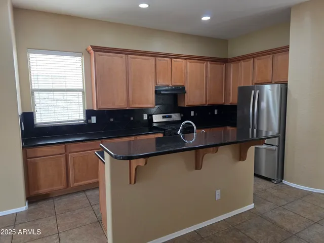 a kitchen with a sink a stove and refrigerator