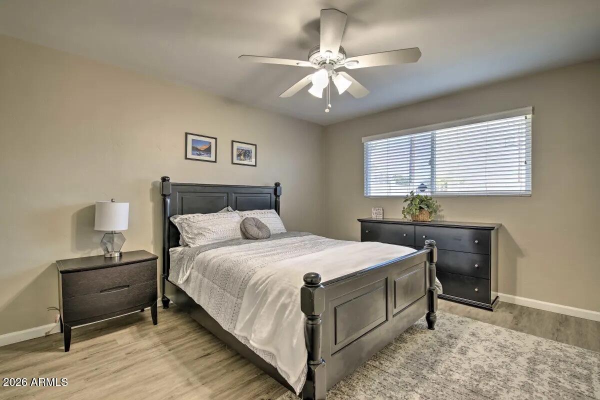 609 South Priest Drive Tempe, AZ 85281 - Photo 12 of 29 a bedroom with a bed and a chandelier