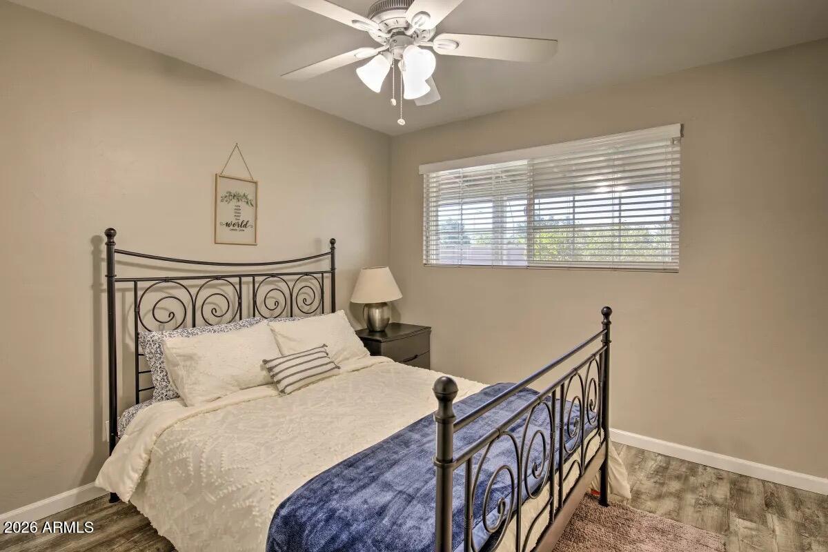 609 South Priest Drive Tempe, AZ 85281 - Photo 17 of 29 a bedroom with a bed and a chandelier